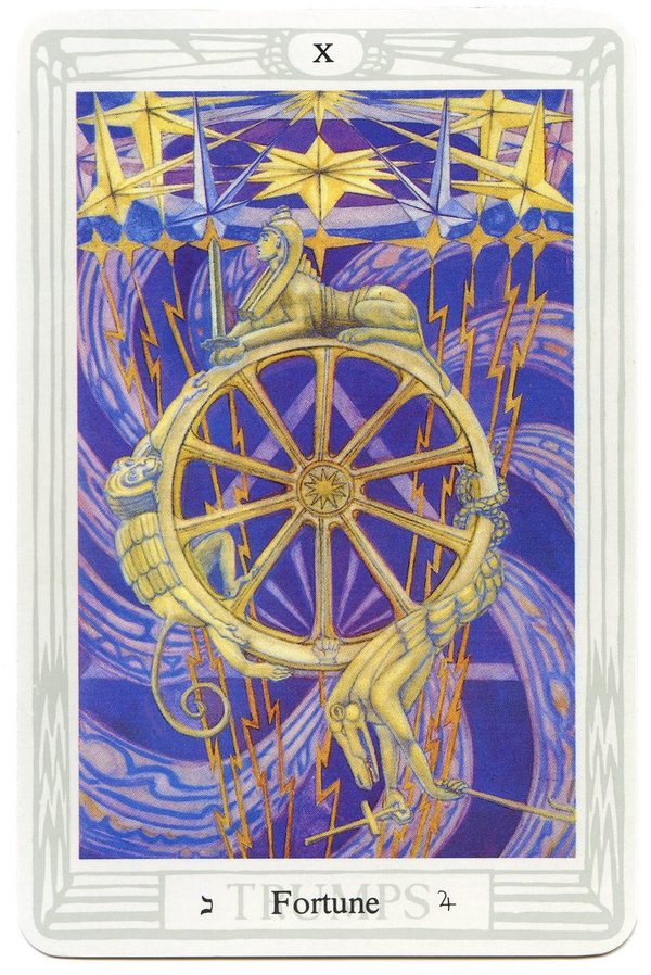 Fortune, Thoth Tarot. A ten-spoked wheel turns in a sky of lightning and stars. Three figures ride it: the sword-bearing Sphinx at the top, the ape-headed Hermanubis climbing, and the crocodile-like Typhon falling. They are sulphur, mercury and salt, and the three gunas of Indian philosophy.